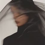 A figure partially obscured by swirling layers of sheer fabric, creating a sense of mystery and grace, as light and shadow interplay to evoke intrigue.