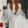 An abstract artwork of a figure in a translucent white garment with long red hair, set against a black-and-white backdrop, exploring vulnerability, emotion, and underlying conflict.