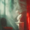 A marble bust illuminated by soft light in an interior setting, surrounded by shadows and smoke. Rich red and green hues frame the composition, with an elegant chair suggesting nostalgia.