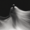 A ghostly figure enveloped in flowing lines, with light and shadow emphasizing its ethereal quality, evoking themes of movement and impermanence.