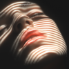 A serene face illuminated by slanted light stripes against a dark background, with rhythmic lines and subtle sheen, evoking calm and contemplation.